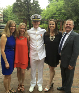Newly commissioned ENS Ben Bushong flanked by his family.